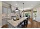 Modern kitchen with granite countertops, gray cabinets, and stainless steel appliances, perfect for culinary enthusiasts at 937 Sedgefield Park Ln, Cary, NC 27519