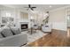 Bright living room featuring a fireplace, stylish furniture, and hardwood floors at 937 Sedgefield Park Ln, Cary, NC 27519