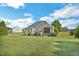 Spacious backyard with lush green grass and a screened in porch; perfect for outdoor living at 95 Live Oak Dr, Louisburg, NC 27549