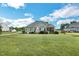 Expansive backyard features a lush lawn, mature trees, and screened-in porch at 95 Live Oak Dr, Louisburg, NC 27549