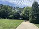 A sprawling backyard features lush greenery, mature trees, and a charming shed, ideal for relaxation at 95 Live Oak Dr, Louisburg, NC 27549