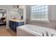 Lovely bathroom with a soaking tub underneath a glass block window at 95 Live Oak Dr, Louisburg, NC 27549