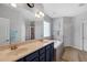 Bright bathroom with double vanity sinks, large mirror, and separate tub and shower at 95 Live Oak Dr, Louisburg, NC 27549