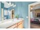 Stylish bathroom features a vanity and a view to an adjoined bedroom at 95 Live Oak Dr, Louisburg, NC 27549