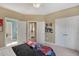 Neutral bedroom with connecting doors to other rooms, a ceiling fan, and a double-door closet at 95 Live Oak Dr, Louisburg, NC 27549