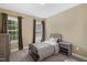 Bedroom with carpet and two windows with blinds and curtains at 95 Live Oak Dr, Louisburg, NC 27549