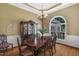 Formal dining room with hardwood floors, decorative chandelier, and natural light from large windows at 95 Live Oak Dr, Louisburg, NC 27549