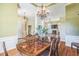 Formal dining room boasts a gorgeous chandelier, hardwood floors, and an open floor plan to the living room at 95 Live Oak Dr, Louisburg, NC 27549