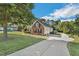 Brick and siding home with a well-maintained lawn and a long driveway; the epitome of curb appeal at 95 Live Oak Dr, Louisburg, NC 27549