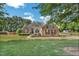 Charming brick and siding home with lush lawn, mature trees and well-maintained landscaping at 95 Live Oak Dr, Louisburg, NC 27549