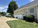 View of the house's three car garage, well maintained lawn and landscaping at 95 Live Oak Dr, Louisburg, NC 27549