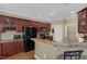 Well-equipped kitchen features granite countertops, dark cabinetry, and breakfast bar at 95 Live Oak Dr, Louisburg, NC 27549