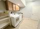 Convenient laundry room features modern appliances, tile flooring and ample storage space at 95 Live Oak Dr, Louisburg, NC 27549