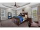Large main bedroom with tray ceilings, ceiling fan and carpet floors at 95 Live Oak Dr, Louisburg, NC 27549