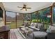 Relaxing screened-in patio featuring comfortable wicker furniture, ceiling fan and views of the private backyard at 95 Live Oak Dr, Louisburg, NC 27549
