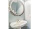 Charming powder room features a pedestal sink with an ornate mirror and soft blue walls at 95 Live Oak Dr, Louisburg, NC 27549