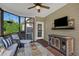 Relaxing screened porch offers outdoor living with a ceiling fan and comfortable seating at 95 Live Oak Dr, Louisburg, NC 27549