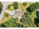 Overhead shot of a home with a driveway, backyard deck, surrounded by lush trees and greenery at 101 Rainbow Dr, Carrboro, NC 27510
