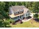 Aerial view of a home with a well-manicured lawn, mature trees, a copper porch roof and green shutters at 101 Rainbow Dr, Carrboro, NC 27510