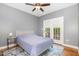 Cozy bedroom features a double bed, sliding glass doors to a patio, and a ceiling fan at 101 Rainbow Dr, Carrboro, NC 27510