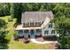 Aerial view of a two-story home featuring a wrap-around porch and green shutters surrounded by mature trees at 101 Rainbow Dr, Carrboro, NC 27510