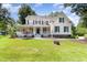 Charming two-story home with a covered porch, manicured lawn, and vibrant green shutters at 101 Rainbow Dr, Carrboro, NC 27510