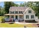 Inviting two-story home with a copper-roofed porch, green shutters, and well-maintained landscaping at 101 Rainbow Dr, Carrboro, NC 27510