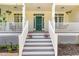 Charming front porch with hanging flower baskets, rocking chairs, and steps leading to the entrance at 101 Rainbow Dr, Carrboro, NC 27510