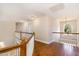 Upstairs hallway features wood floors, white railings, and a bright window at 101 Rainbow Dr, Carrboro, NC 27510