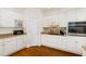Kitchen features white cabinets, hardwood floors, and modern appliances at 101 Rainbow Dr, Carrboro, NC 27510