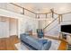Open-concept living room with a vaulted ceiling, fireplace, hardwood floors, and a staircase at 101 Rainbow Dr, Carrboro, NC 27510