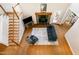Open living room with hardwood floors, fireplace, staircase, and natural light at 101 Rainbow Dr, Carrboro, NC 27510