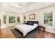 Spacious main bedroom with wood floors, tray ceilings, and large windows at 101 Rainbow Dr, Carrboro, NC 27510