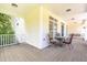Covered porch featuring a table, chairs, and a swing, offering a relaxing outdoor space at 101 Rainbow Dr, Carrboro, NC 27510