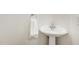 Clean powder room features a pedestal sink and modern fixtures at 101 Rainbow Dr, Carrboro, NC 27510