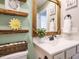 Bathroom with modern vanity, decorative mirror, and rustic shelving at 1015 E Maplewood, Benson, NC 27504