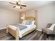 Comfortable bedroom with a four-poster bed, chair, and wood-look flooring at 1015 E Maplewood, Benson, NC 27504