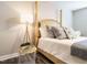 Well decorated bedroom featuring a four-poster bed, stylish side table, and warm lighting at 1015 E Maplewood, Benson, NC 27504