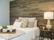 Bedroom featuring an accent wall, table lamp, and a comfortable bed with decorative pillows at 1015 E Maplewood, Benson, NC 27504