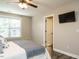 Cozy bedroom featuring a ceiling fan, window, and a wall-mounted TV for relaxing entertainment at 1015 E Maplewood, Benson, NC 27504