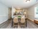 Cozy dining area leading to a modern kitchen with stainless steel appliances and granite countertops at 1015 E Maplewood, Benson, NC 27504