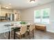 Bright dining area with views of the yard, adjacent to a well-equipped kitchen at 1015 E Maplewood, Benson, NC 27504