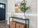 Stylish entryway with decorative table, artwork, and a dark blue front door at 1015 E Maplewood, Benson, NC 27504