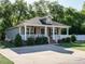 Inviting home featuring a covered front porch, complemented by mature landscaping and a well-maintained lawn at 1015 E Maplewood, Benson, NC 27504