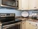 Kitchen featuring stainless steel oven and microwave, and white cabinets at 1015 E Maplewood, Benson, NC 27504