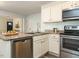 Bright kitchen with stainless steel appliances and a view to the entry hall at 1015 E Maplewood, Benson, NC 27504
