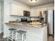 Charming kitchen with granite countertops, stainless steel appliances, and breakfast bar with seating at 1015 E Maplewood, Benson, NC 27504