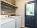 Functional laundry room with washer, dryer, shelving and exterior door at 1015 E Maplewood, Benson, NC 27504