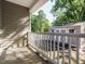 Covered porch with railing and view of backyard shed, providing a relaxing outdoor space at 1015 E Maplewood, Benson, NC 27504