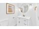Modern bathroom with round mirror, white vanity, and gold hardware at 102 Lake Dr, Wendell, NC 27591